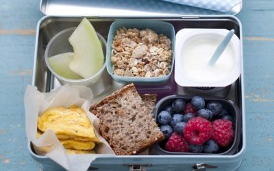 Matpakke med brød, eggerøre, yoghurt, musli, frukt og bær til først skoledag