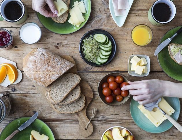 Frokostbord med grovbrød, ost, skinke, frukt og grønnsaker