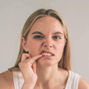 Dame med blødende tannkjøtt