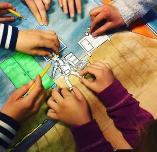 Barnehender leker med utklippsfigurer.