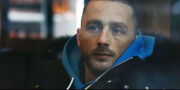 Mann som ser gjennom et vindu