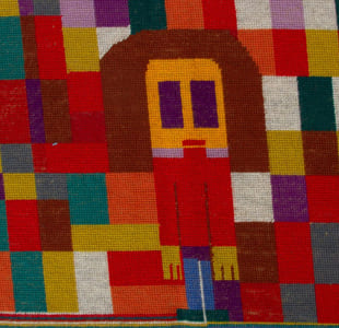 Et fargerikt vevd teppe. I midten ses en menneskefigur.