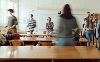 En lektor venter på elevene i et klasserom. Bilde.