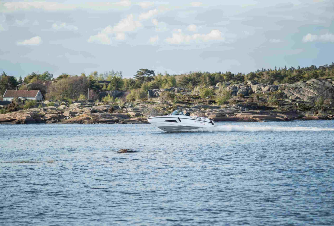 Sporty landsstedsbåt, Tha 9328-27, i fart i skjærgården