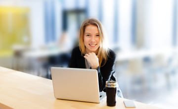 Kvinne som betaler avtalegiro eller efaktura på laptopen sin