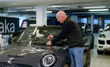 bytter vindusviskere på bilen sin