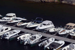 Båter som står på bryggeplassene sine langs en brygge