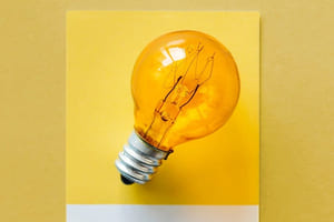 Foto av gul lyspære på gul bakgrunn